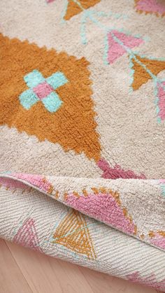 a close up of a rug on a wooden floor