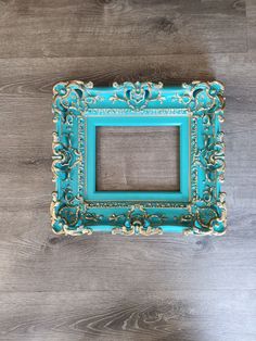 an ornate blue frame on a wooden surface