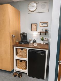 a small kitchen with a black refrigerator and coffee maker