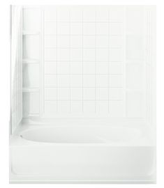 a white bath tub sitting next to a shower head in a bathroom with tiled walls