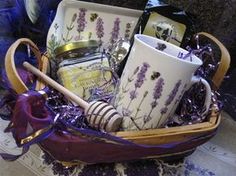 a basket filled with lots of different items on top of a table next to a purple ribbon