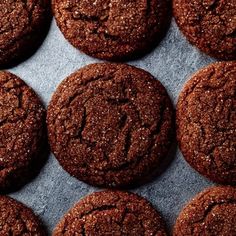 chocolate cookies are lined up on a baking sheet