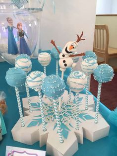 there are some cake pops and marshmallows on the table with snowmen