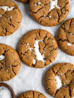 chocolate cookies with white crumbs and powdered sugar on the top one cookie has been cut in half