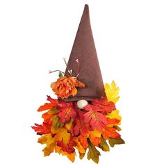 a brown hat with orange and yellow leaves on the top is hanging from a hook