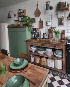 a kitchen filled with lots of pots and pans on top of a wooden table