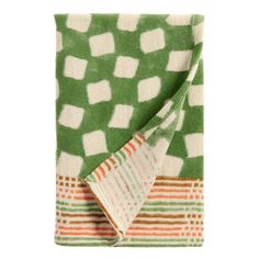 a green and white blanket folded on top of each other