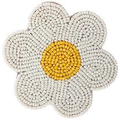 a white and yellow flower with two petals on the center, surrounded by small beads