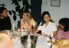 a group of people sitting around a dinner table