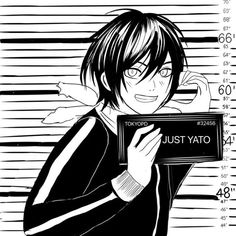 an anime character holding up a sign that says just yato in front of him