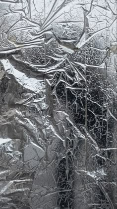 an abstract photograph of trees and snow covered ground