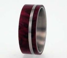 a wedding ring with red wood and silver inlay