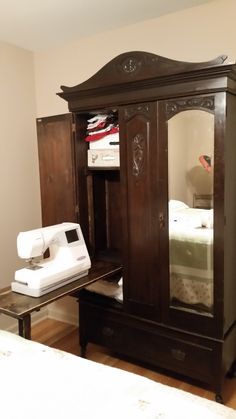 an armoire and sewing machine in a room