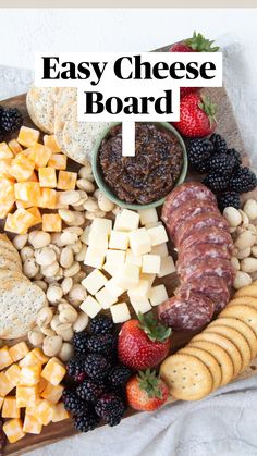 an assortment of cheeses, crackers and fruit on a platter with strawberries