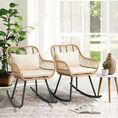 two wicker chairs sitting next to each other on a rug in front of a window