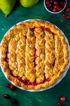 a pie with cranberry filling on a green table