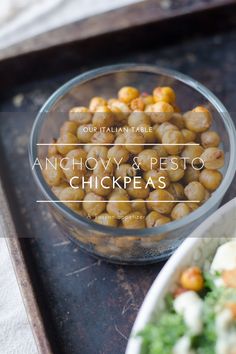 anchovy and pesto chickpeas in a glass bowl on a tray