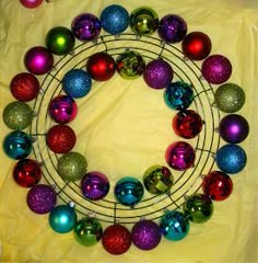 a wreath made out of christmas ornaments on a table