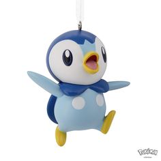 a blue and white penguin ornament hanging from a string