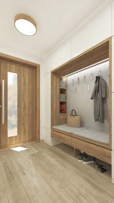 a wooden bench sitting in front of a door next to a bag and coat rack