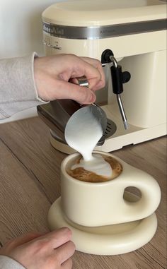 a person pours coffee into a cup