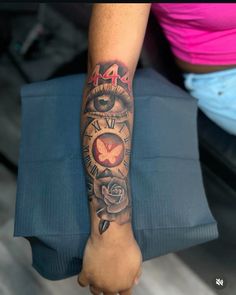 a woman's arm with a clock and roses tattoo on it