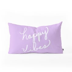 a purple pillow with the words happy vibes printed on it, sitting against a white background