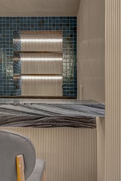 a bath room with a tub and a mirror on the wall next to a chair