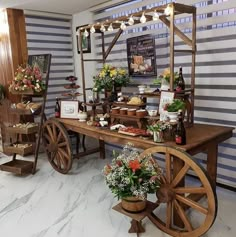 a wooden wagon with flowers on it sitting in front of a table filled with food