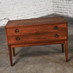 a small wooden table with two drawers on one side and an open drawer on the other