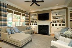 a living room filled with furniture and a fire place