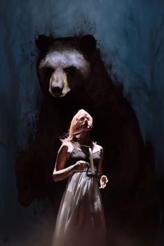 a woman standing in front of a black bear