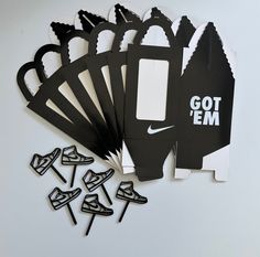 a bunch of black and white paper cutouts sitting on top of each other