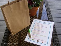 a brown paper bag sitting on top of a table next to a notepad and pen