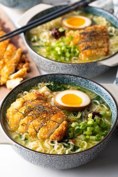 two bowls of ramen with eggs and vegetables