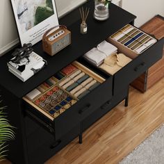 a black desk with drawers and pictures on it