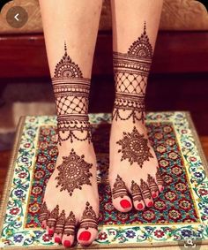 the legs and feet of a woman with henna tattoos