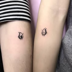 two people with matching tattoos on their arms