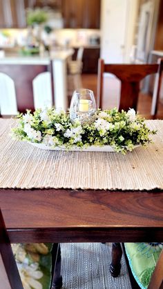 a place setting with flowers and candles on the centerpiece is ready to be served