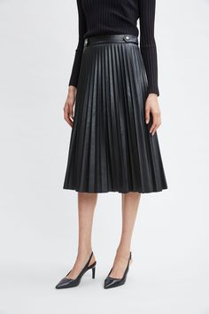 Versatile and undeniably chic, our Vegan Leather has the luxe touch and patina we wanted for our pleated midi skirt. With its gold buttons at the waist, it has the cool factor you are looking for. Pair it with our body skimming knits or soft blouses for an effortless day-to-dinner look. T-Tahari Vegan Leather Pleated Midi Skirt 100% Polyurethane Runs true to Size Model is 5'9" and wearing size S Dry Clean Only Imported Style #: THF49029 Long Sleeve Short Dress, Black Midi Skirt, Pleated Midi Skirt, Knit Tees, Denim Coat, Knit Jacket, Gold Buttons, Our Body, The Cool