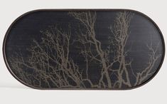 a black and gold tray with trees on the side, in front of a white background