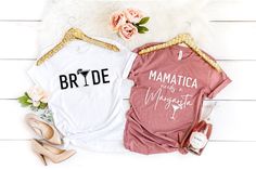 two shirts that say bride and baby's on them next to some shoes with flowers