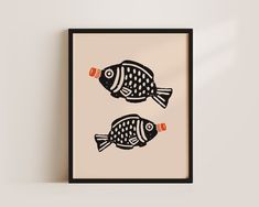 two black and white fish on a beige background