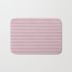 a pink and white striped bath mat