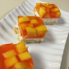 two pieces of mango cream cheese delight on a white plate with the title above it