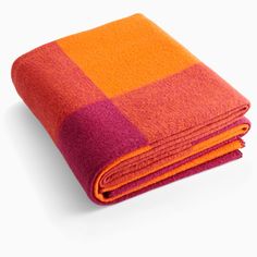 an orange and pink blanket folded on top of each other