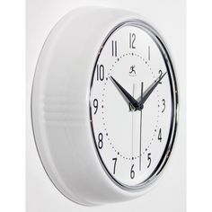 a white wall clock with black hands and numbers