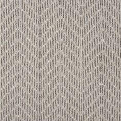 a close up view of the texture of a rug with grey and white herringbones