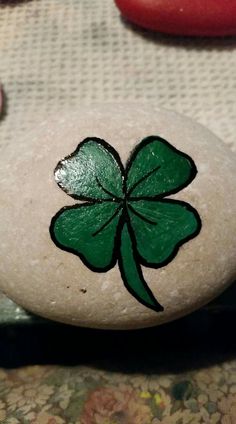 a rock with a shamrock painted on it