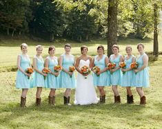 a group of women standing next to each other on top of a grass covered field